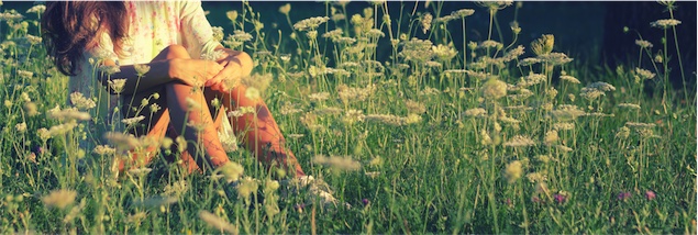 women sitting in a field of yarrow a herb for female health