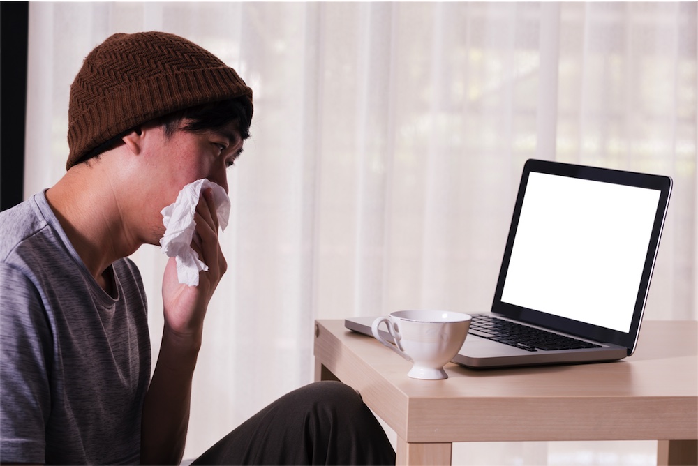 young man with head cold on naturoapth telehealth appointment